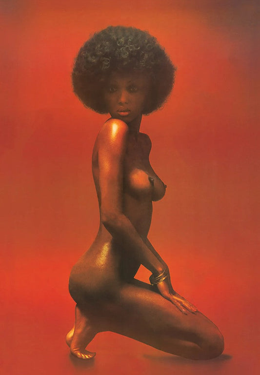 Unidentified Black woman with a large Afro photographed against a red background, seen above Dick Hallorann’s bed in The Shining.