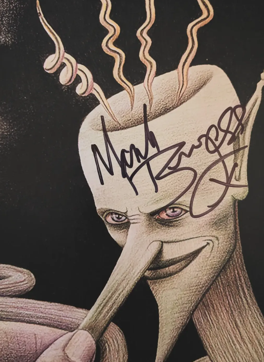 Signed illustration on the sleeve of The Chameleons' Strange Times, Mark Burgess's autograph across the character's forehead.